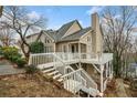 This home boasts a spacious back deck area perfect for outdoor gatherings, and stairs lead to a lower yard area at 1675 Paddlewheel Dr, Marietta, GA 30062