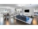 Bright and airy living room featuring hardwood floors, open floor plan, and connection to the kitchen and dining areas at 1783 Mckenzie Dr, Decatur, GA 30032