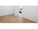 Bright bedroom doorway showcases hardwood floors and minimalist design at 2657 Ashford Ne Rd, Brookhaven, GA 30319