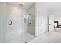 Beautiful bathroom with marble walk-in shower, hexagon tiling and gold fixtures at 2657 Ashford Ne Rd, Brookhaven, GA 30319