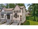 View of the stylish townhome with a two-car garage and brick facade at 4524 Mikajack Se Dr, Smyrna, GA 30080
