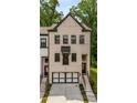 Charming townhome with a modern two-car garage and brick facade at 4524 Mikajack Se Dr, Smyrna, GA 30080