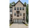 Charming townhome with a modern two-car garage and brick facade at 4524 Mikajack Se Dr, Smyrna, GA 30080