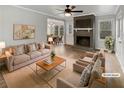 Bright living room with a brick fireplace, ceiling fan, and wood floors at 6390 E Stubbs Rd, Atlanta, GA 30349