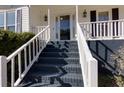 Inviting front porch with freshly painted black stairs and white railings, leading to a glass-paneled front door at 2167 Tully Wren Ne, Marietta, GA 30066