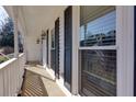 Charming covered front porch with black shutters, white railing, and views of the landscaped front yard at 2167 Tully Wren Ne, Marietta, GA 30066