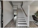 Bright foyer featuring hardwood floors, a staircase with dark banister, and high ceilings at 3410 Summerpoint Xing, Cumming, GA 30028