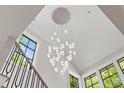 Staircase area featuring a modern chandelier hanging from the high ceiling at 42 Blackland Nw Rd, Atlanta, GA 30342