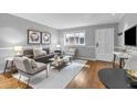 Cozy living room with light-filled window features hardwood floors, gray walls with white trim, and comfortable seating at 343 8Th Ne St # G2, Atlanta, GA 30309