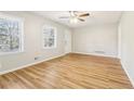 Sunlit living room boasts windows, modern vinyl flooring, neutral walls, and a ceiling fan at 6071 Cristie Dr, Ellenwood, GA 30294