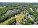 Gorgeous aerial view of new construction community with mature trees and a manicured golf course at 222 Trecastle Sq # 21, Canton, GA 30114