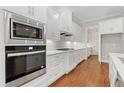 Bright kitchen with stainless appliances, white cabinets, granite counters, and hardwood floors at 222 Trecastle Sq # 21, Canton, GA 30114