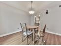 Well-lit dining area with laminate flooring and a view into the adjacent kitchen provides seamless flow at 654 Powers Ferry North Se, Marietta, GA 30067