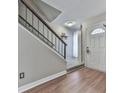 Inviting entryway features wood flooring and a staircase with wood and wrought iron banister at 654 Powers Ferry North Se, Marietta, GA 30067