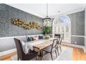 A modern dining room with stylish decor, including a light fixture and large window at 2447 Gatebury Cir, Chamblee, GA 30341