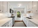 Galley kitchen with stainless steel appliances, white cabinets, and ample counter space at 104 Terrace Dr # 6, Atlanta, GA 30305