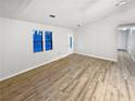 Bright living room featuring sleek wood floors, fresh paint, and ample natural light from the large windows at 1487 Arnold Dr, Lawrenceville, GA 30043