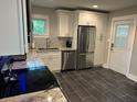 Well-lit kitchen featuring modern stainless steel appliances, granite countertops, and herringbone tile floors at 2314 Bryant Dr, Atlanta, GA 30344