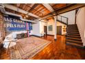 Spacious living room with hardwood floors, open staircase, and exposed ceiling beams at 342 Marietta Nw St # 8, Atlanta, GA 30313