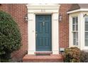 Inviting front entrance featuring a classic teal door and decorative architectural details at 810 Towergate Pl, Atlanta, GA 30350