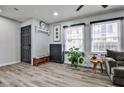 Stylish living room featuring wood-look flooring, modern decor, and plenty of natural light at 15 Pine Canyon Sw Dr, Atlanta, GA 30331