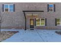 Close up of the front door and covered entrance of a brick duplex at 2381 Highpoint Rd, Snellville, GA 30078