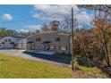 Gray brick duplex on a tree-lined street with lush landscaping at 2381 Highpoint Rd, Snellville, GA 30078