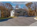 Side view of a gray brick duplex with black shutters surrounded by mature trees at 2381 Highpoint Rd, Snellville, GA 30078