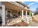 Inviting front porch featuring stone flooring and comfortable seating, perfect for relaxing at 343 Woodstone Dr, Marietta, GA 30068