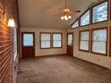 Bright living room featuring a wall of windows, a ceiling fan and neutral carpeting at 1046 Sans Souci Way, Clarkston, GA 30021