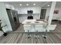 Bright kitchen features a center island with barstools and stainless steel appliances at 2346 Pryor Sw Rd, Atlanta, GA 30315