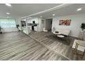 Open living space with modern flooring, bright white walls, and a view of the kitchen at 2346 Pryor Sw Rd, Atlanta, GA 30315