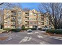 Multi-story condo building with tan exterior, brick accents, balconies and front parking at 4203 Stratford Commons # 4203, Decatur, GA 30033