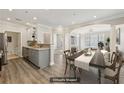 Staged living room and kitchen featuring hardwood floors, stainless appliances, and an open concept layout at 4203 Stratford Commons # 4203, Decatur, GA 30033