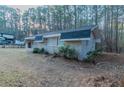 Side view of a brick home with a dark roof and small bushes around the perimeter at 645 Plainville Sw Dr, Atlanta, GA 30331