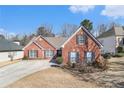 Charming one-story brick home with landscaped front yard and classic black shutters at 1176 Whatley Mill Ln, Lawrenceville, GA 30045