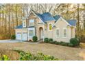 Traditional two-story home featuring a stone facade and well-maintained landscaping at 2685 Lenora Church Rd, Snellville, GA 30078