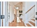 Inviting foyer with hardwood floors, a view into the living room, and staircase at 2685 Lenora Church Rd, Snellville, GA 30078