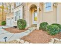 Close-up of the front entrance with a stone pathway, elegant doorway, and manicured bushes at 2685 Lenora Church Rd, Snellville, GA 30078