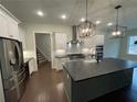 This spacious kitchen features stainless steel appliances, a large island, and pendant lighting at 222 Blossom Trl, Acworth, GA 30101