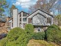 Charming two-story home featuring a wood facade, multi-level deck, and mature landscaping at 2541 Deer Isle Cv, Lawrenceville, GA 30044