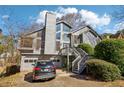 Charming two-story home featuring a wood facade, multi-level deck, and attached two-car garage at 2541 Deer Isle Cv, Lawrenceville, GA 30044