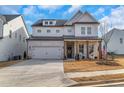 Charming two-story home featuring a brick and siding exterior, inviting front porch, and well-manicured lawn at 335 Tillman Pass, Woodstock, GA 30188