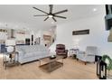 Bright living room featuring hardwood floors, neutral-colored sofas, and an open layout to the kitchen at 335 Tillman Pass, Woodstock, GA 30188