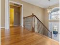 Inviting foyer with hardwood floors, decorative railing and a charming chandelier at 8885 Camp Tree Ct, Winston, GA 30187