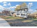 Charming two-story home with a manicured lawn and inviting entryway, painted white with black shutters at 3187 Clifton Church Rd, Atlanta, GA 30316