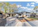 Charming two-story home with a manicured lawn and inviting entryway, painted white with black shutters at 3187 Clifton Church Rd, Atlanta, GA 30316
