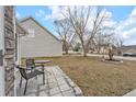 Outdoor patio with stone pavers, seating area, and well-kept lawn at 4750 Millenium View Ct, Snellville, GA 30039