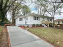 Charming single-story home featuring a concrete driveway and a well-maintained, landscaped front yard at 2495 Se Glendale Se Cir, Smyrna, GA 30080