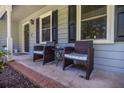 Inviting front porch with two chairs and a small table by the windows at 4230 Deerwood Se Pkwy, Smyrna, GA 30082